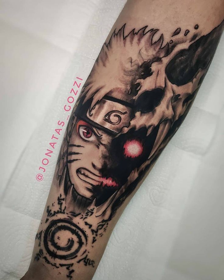 a man's arm with a tattoo on it that has an image of a demon and