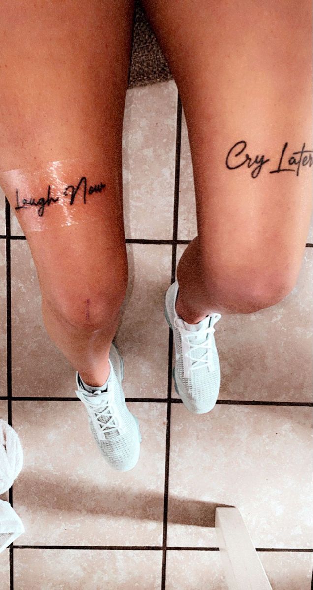 two people with tattoos on their legs standing in front of a tiled floor and wall