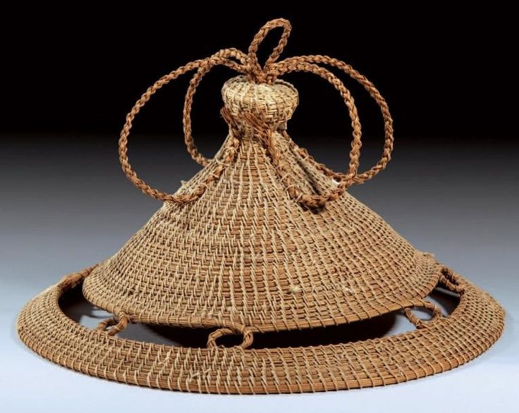 a large woven basket with a bow on it's head and two strings hanging from the top