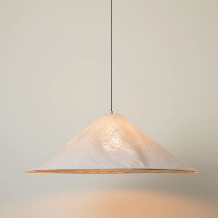 a white light hanging from a ceiling in a room