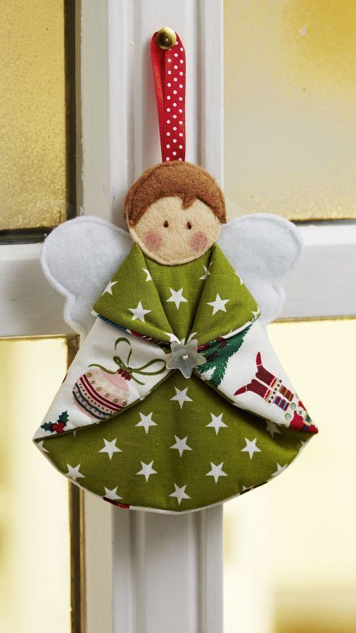 an ornament hanging from the side of a door with a christmas angel on it