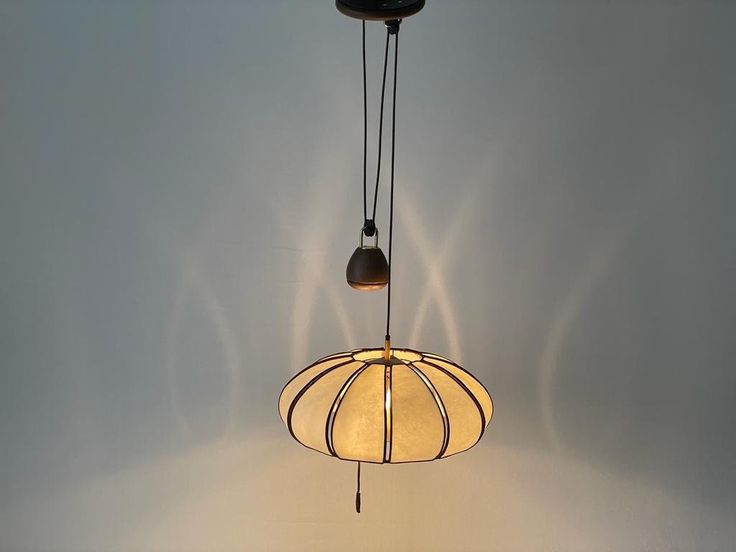 a light fixture hanging from the ceiling with two lights attached to it's sides