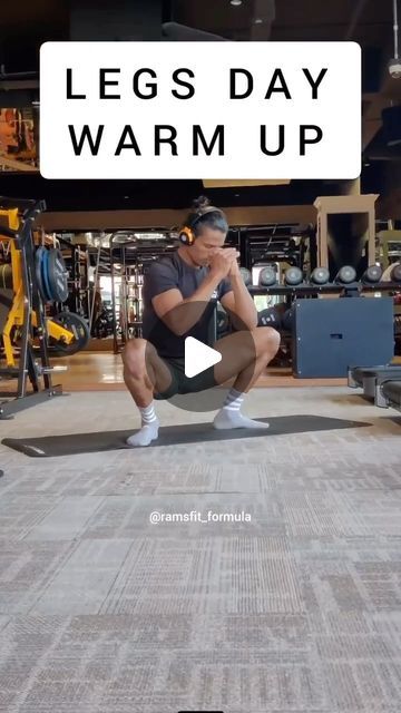 a man squatting on the floor in front of a gym equipment rack with words saying legs day warm up