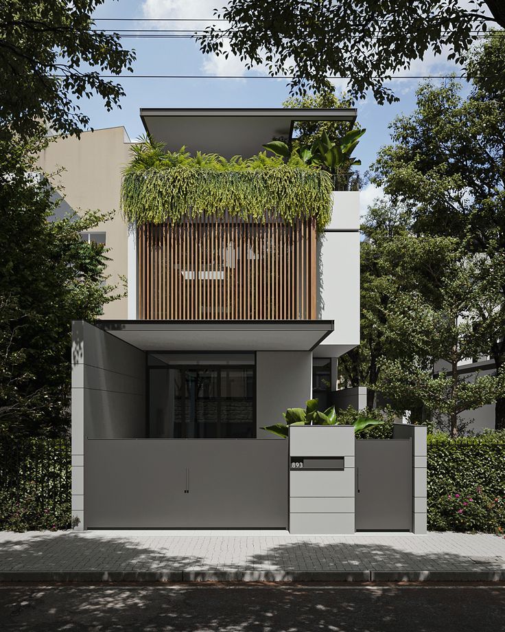 a modern house with plants growing on the roof