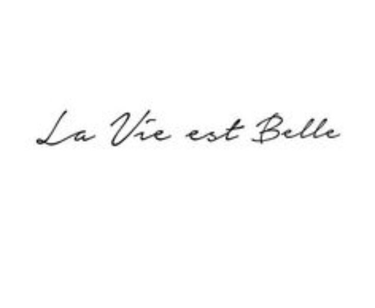 the word la vie est belle written in black ink