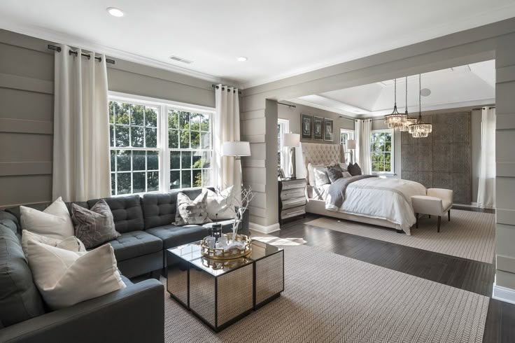 a living room filled with furniture and lots of windows