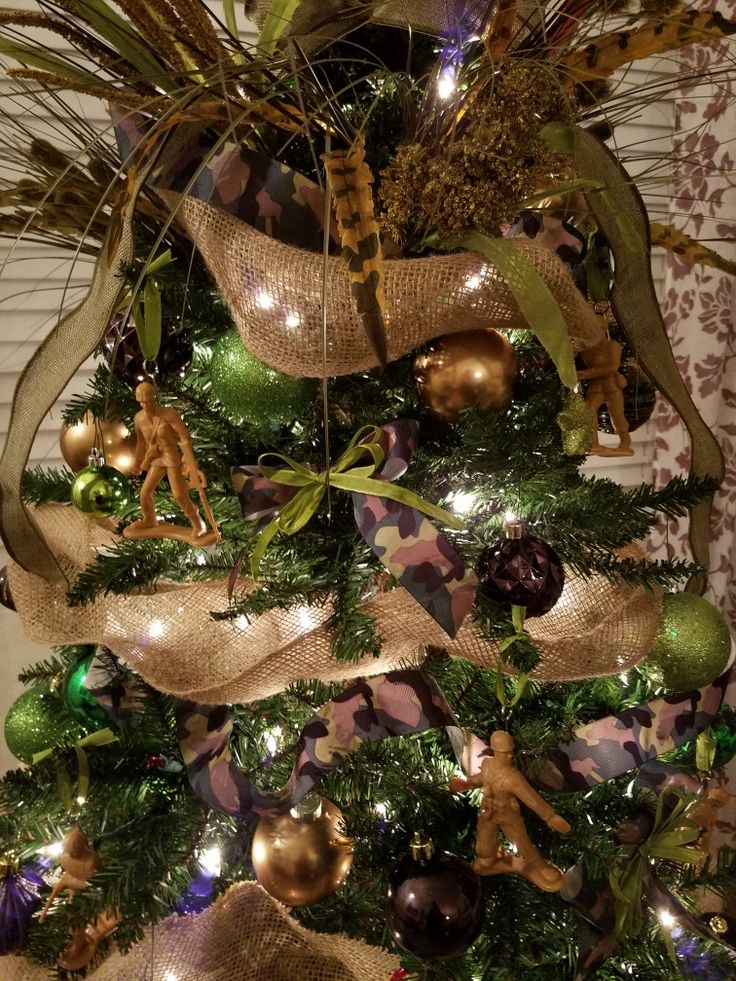 a christmas tree decorated with gold and green ornaments