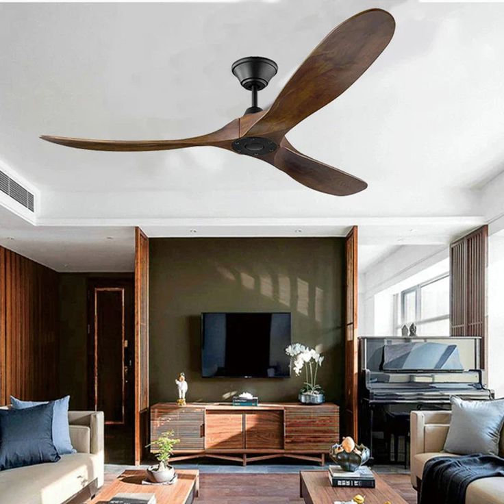 a living room with couches and a ceiling fan in it's centerpiece