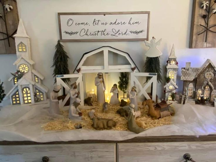 a nativity scene is displayed on top of a dresser