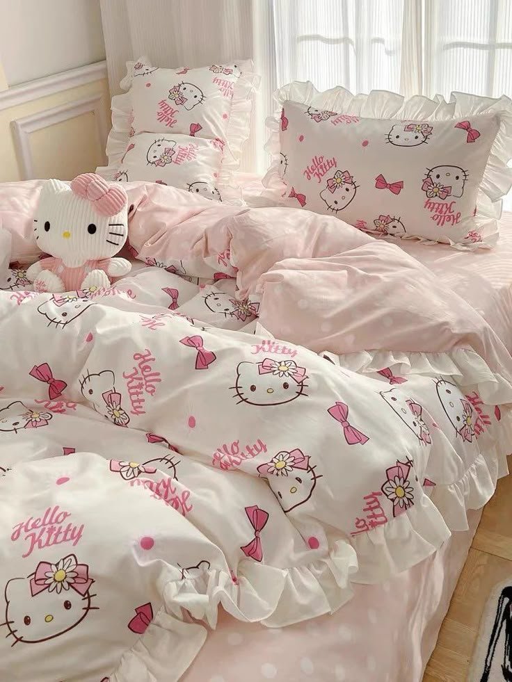 a hello kitty bed set with pink and white sheets