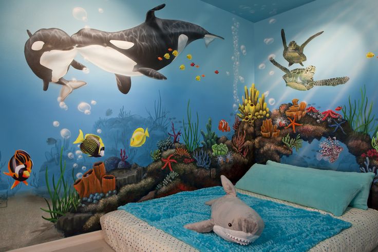 an underwater themed bedroom with dolphins and other animals