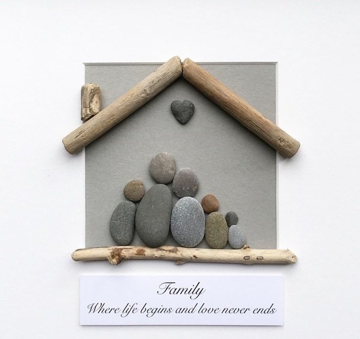 there are rocks in the shape of a house and a sign that says family where life begins and love never ends