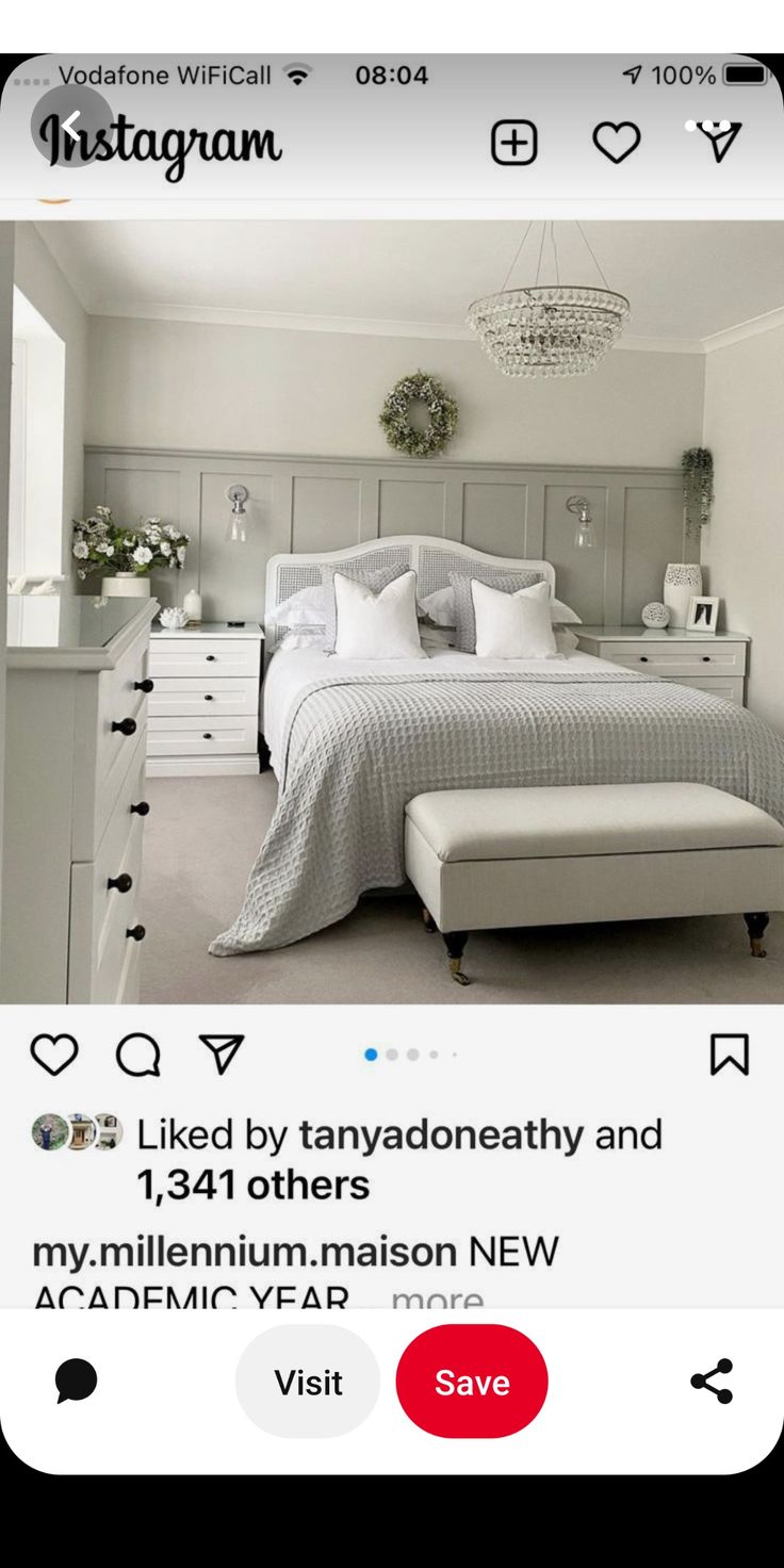 an instagramted photo of a bedroom with white furniture and gray bedding in the background