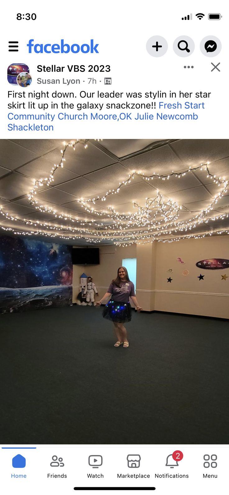 a woman standing in a room with lights on the ceiling and an instagram page below