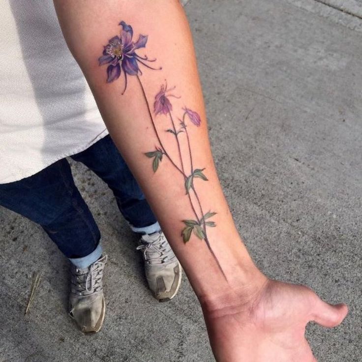 a person with a flower tattoo on their arm