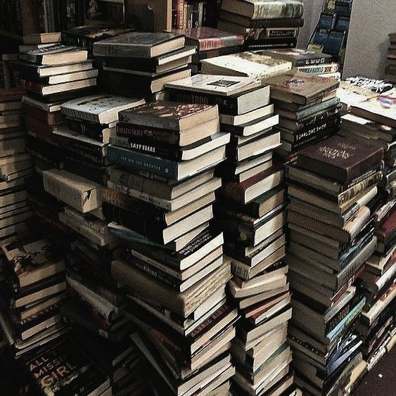 many books are stacked on top of each other