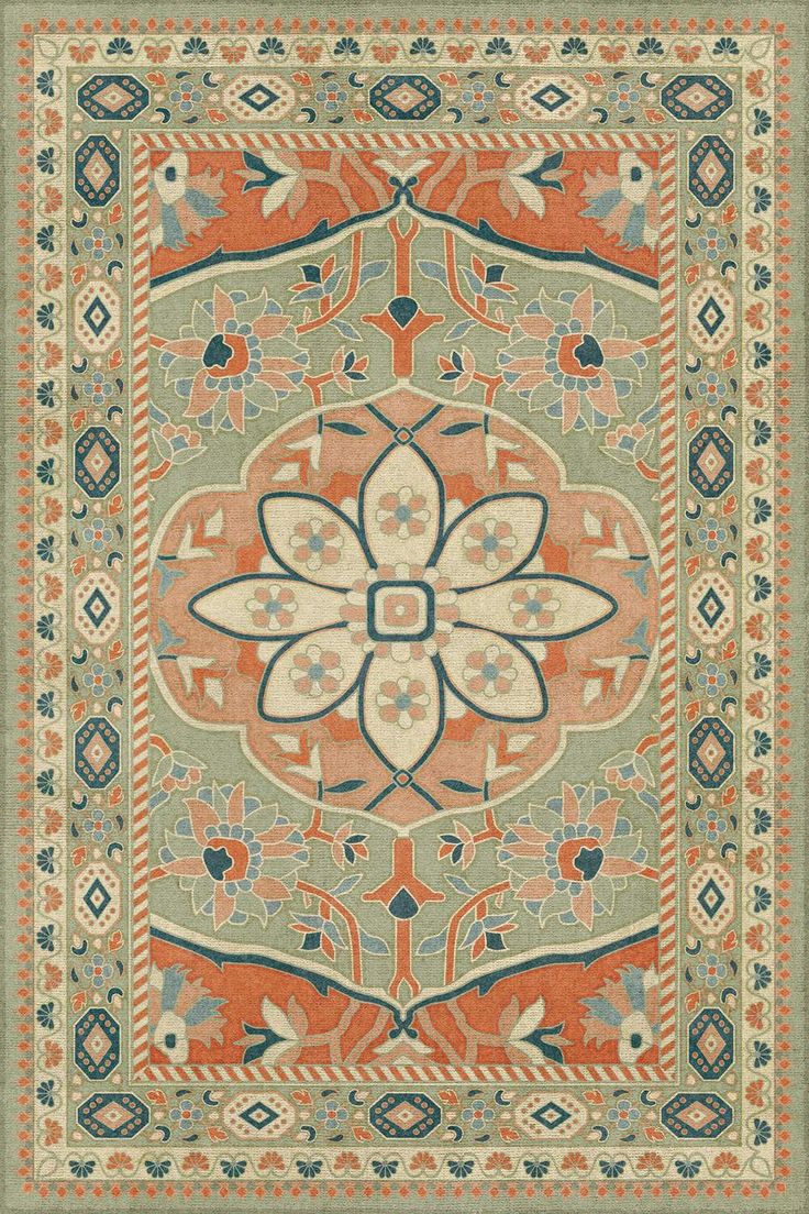 an orange and blue rug with floral designs on the center, surrounded by other decorative elements