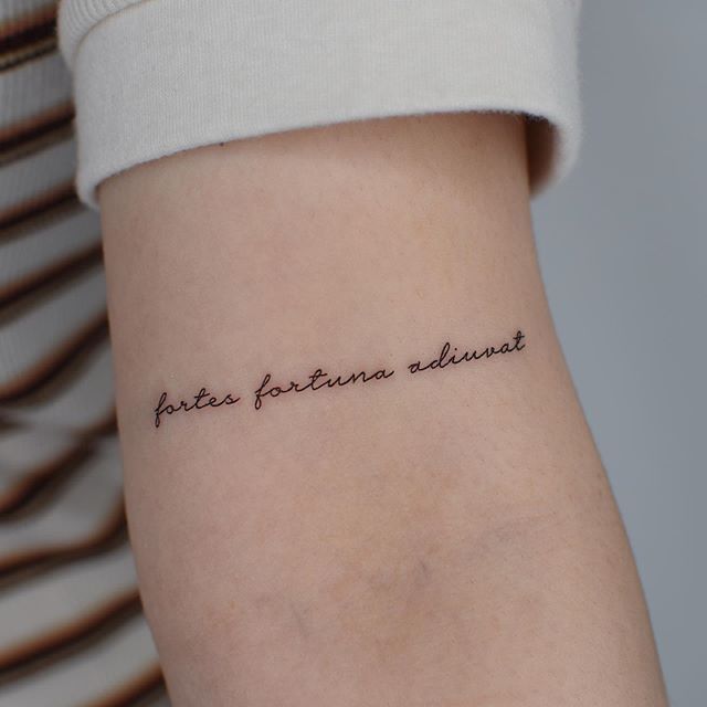 a woman with a tattoo on her thigh that says, future fortune always