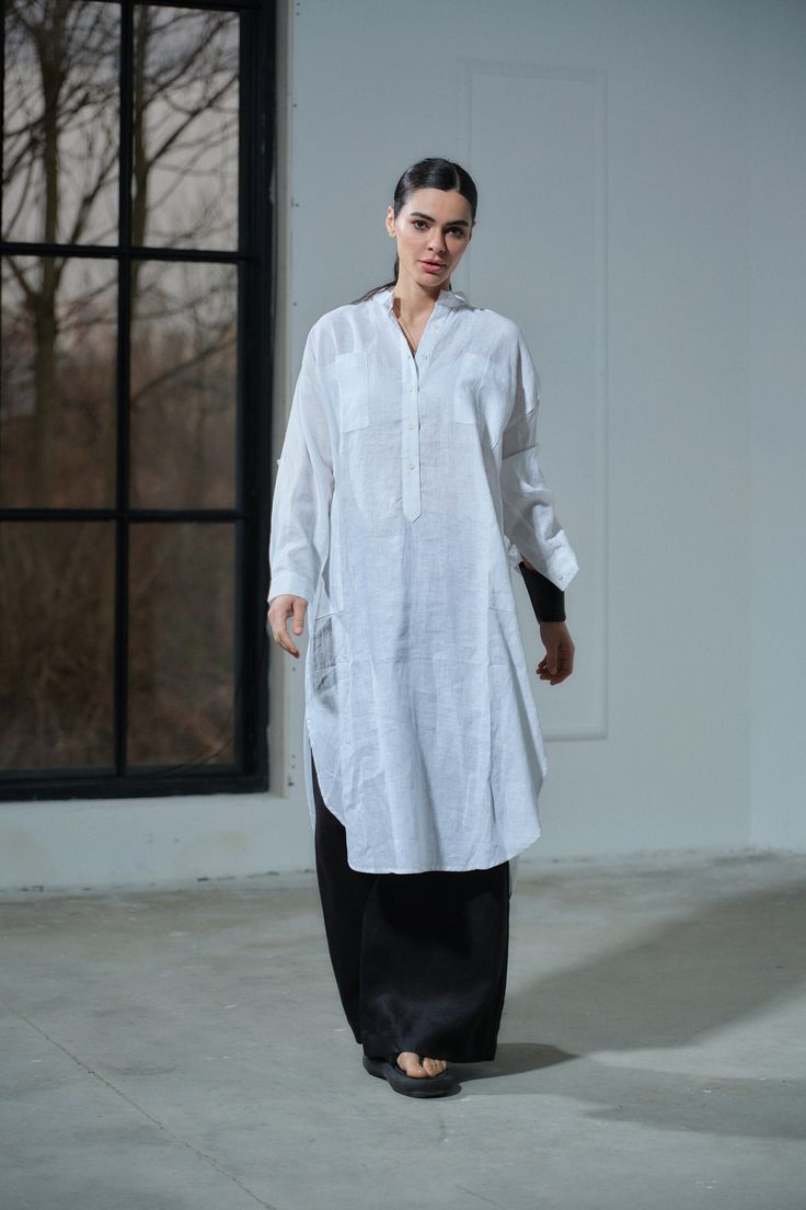 Elevate your summer wardrobe with our White Linen Oversized Kaftan, a stunning blend of elegance and comfort. Handmade from 100% pure, lightweight linen, this kaftan is OEKO-TEX® certified, ensuring that it's free from harmful substances. The relaxed fit drapes gracefully, complemented by a V-neck with a collar and buttons for a touch of sophistication. Long sleeves with cuffs and roll-up button tabs add versatility to your look, making it perfect for both beach vacations and urban adventures. D Oversized Bohemian Linen Maxi Dress, Linen Long Sleeve Tunic For Vacation, Long Sleeve Linen Tunic For Vacation, Oversized Long Tunic For Daywear, Lagenlook Long Sleeve Linen Tunic, Oversized Linen Long Sleeve Tunic, Oversized Long Sleeve Linen Tunic, Bohemian Linen Kurta For Summer, Relaxed Fit Long Sleeve Linen Kurta