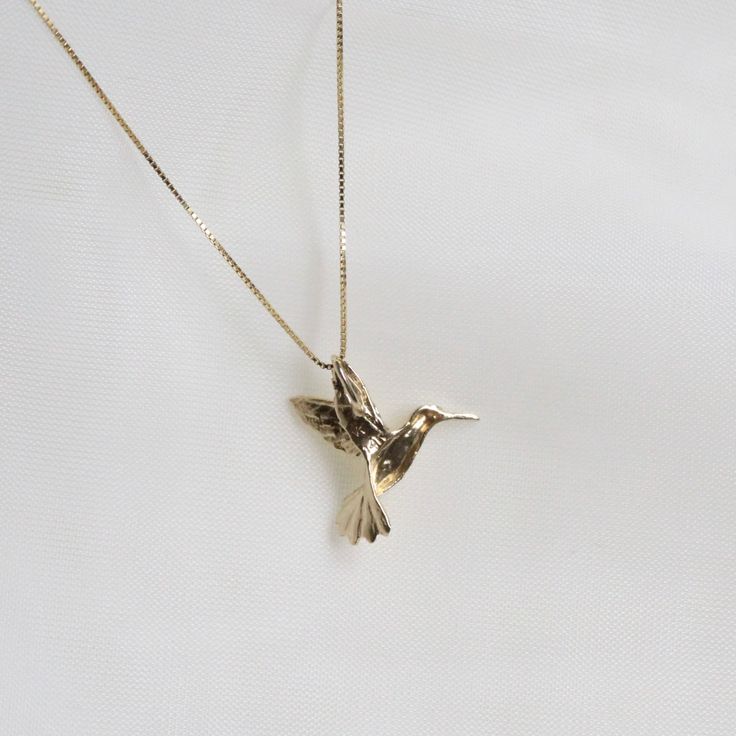 "Humming Bird Pendent Necklace . . . * Pendants Measurements With Bail: (16 x18 mm) * Gold KT: 14K Gold * Gold Color: Yellow Gold * Chain: Optional * Chain: 1 Box Chain * Stamp: 14k * Never gold filled or plated * 1-Day Shipping * Packaged With Free Gift Box . . . If you have any questions, just hit the \"Message the Seller\" button ( bottom right of the page) and we will get back to you within a few hours. . . . Check our Social Media @Talajewel, and let's be friends!  . . . Made in USA, Humming Bird Pendent Necklace, 14k Solid Yellow Gold Dainty Bird Necklace, Tiny Bird Necklace, Solid 14k Gold Charm, Gold Bird Necklace, Gift for babies, 14K Bird Charm Pendant, 14k solid gold Bird necklace, yellow gold necklace, thin chain, Dainty good luck necklace, Great for Layers. A Perfect 14K Gold Gold Bird Necklace, Hummingbird Aesthetic, Pendents Gold, Hummingbird Jewelry, Scorpio Necklace, Dainty Pendant Necklace, Hummingbird Necklace, Astrology Jewelry, Good Luck Necklace