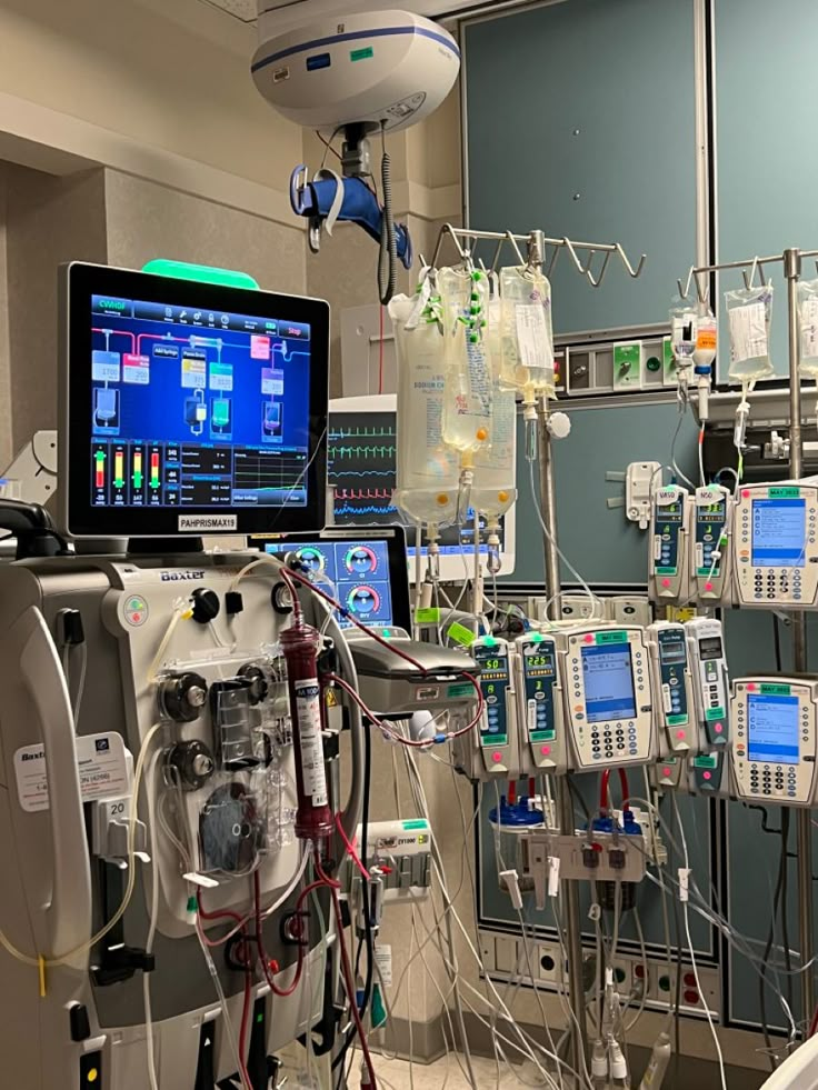 an operating room with medical equipment and monitors on the wall, all connected to each other