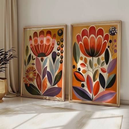 two framed art pieces with flowers on them