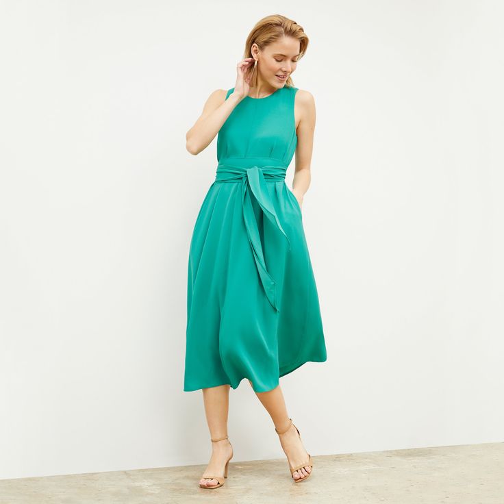 If a beautiful summer day were reincarnated as a piece of clothing, it would look like the Fatima dress. This elegant number features a relaxed fit, subtle A-line, and optional sash for your waist. This fabric is made from responsibly forested wood pulp and recycled polyester. Summer A-line Midi Dress For Daywear, Feminine Green A-line Midi Dress, Breezy A-line Spring Dress, Spring A-line Dress With Tie Waist, Summer A-line Maxi Dress With Tie Waist, Chic Sleeveless Dress For Summer Garden Party, Flowy Midi Dress With Tie Waist, Flowy A-line Sleeveless Dress For Garden Party, Green A-line Midi Dress For Beach