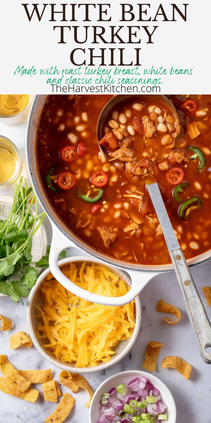 white bean and turkey chili in a large pot with tortilla chips on the side