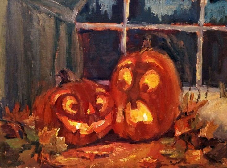 two carved pumpkins sitting in front of a window