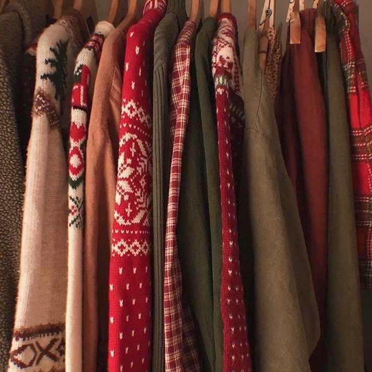 many sweaters are hanging on the clothes rack