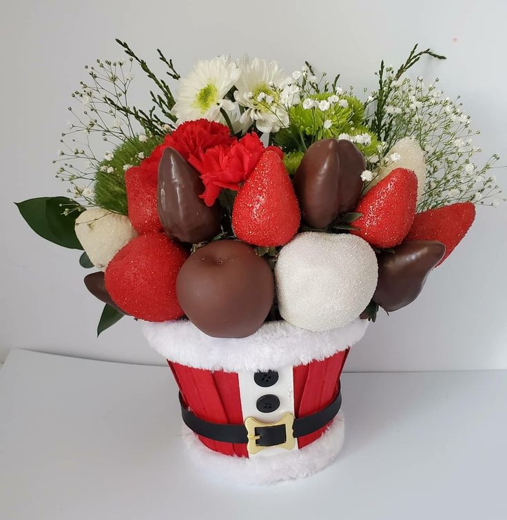 a santa hat filled with chocolates and flowers