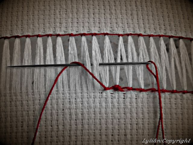 an image of some red thread on the side of a piece of fabric that has been stitched together