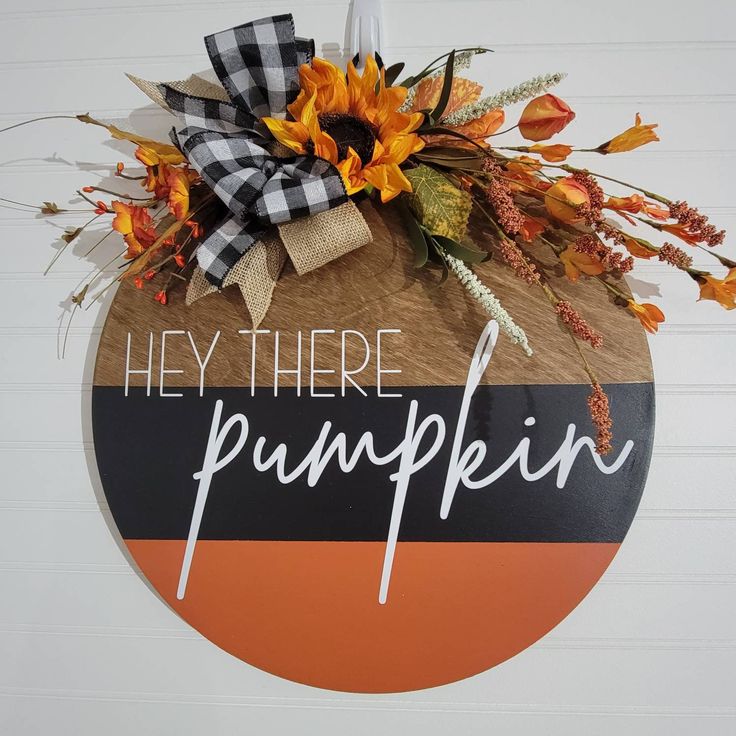 a sign that says hey there pumpkin with sunflowers and fall leaves on it