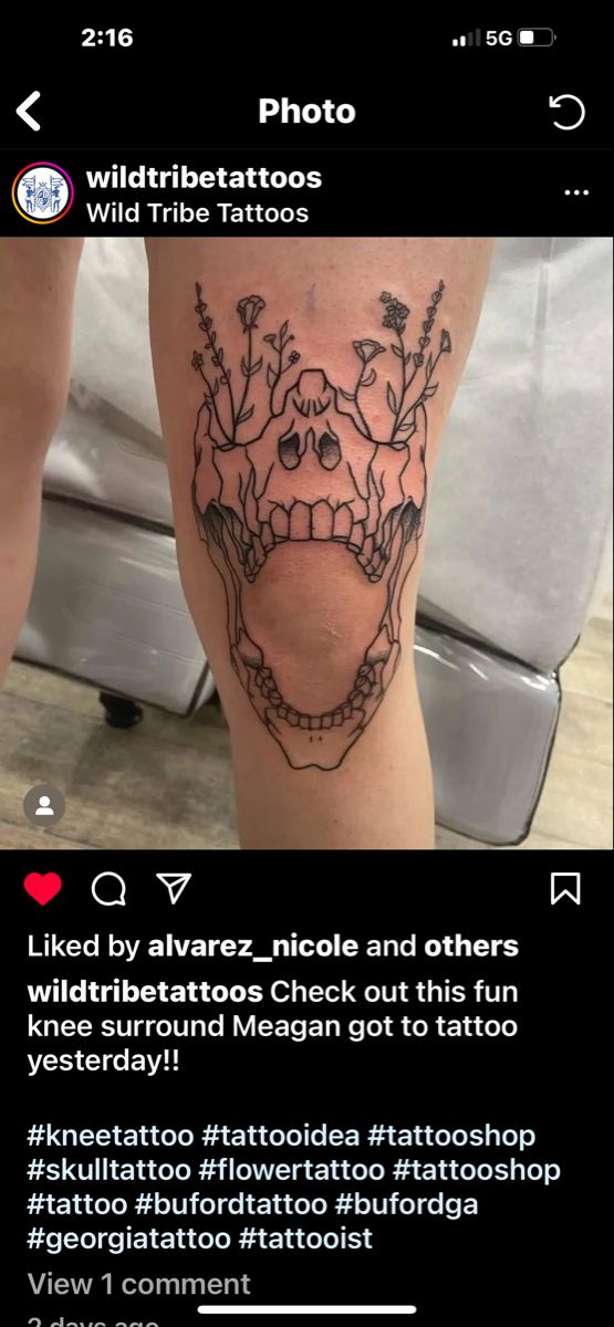 a tattoo on someone's leg with an image of a skull and flowers in the middle