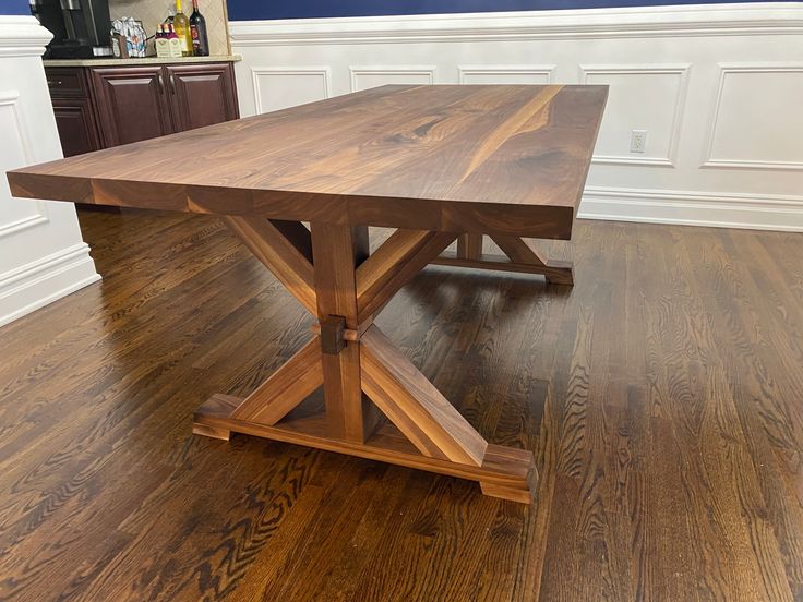 a large wooden table sitting on top of a hard wood floored flooring area