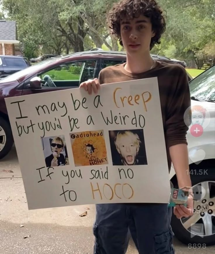 a young man holding up a sign that says i may be a creep but you're a weird person if you said no to hoo