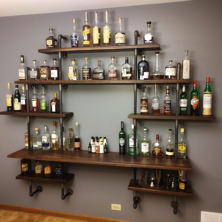 several shelves with liquor bottles on them in a room