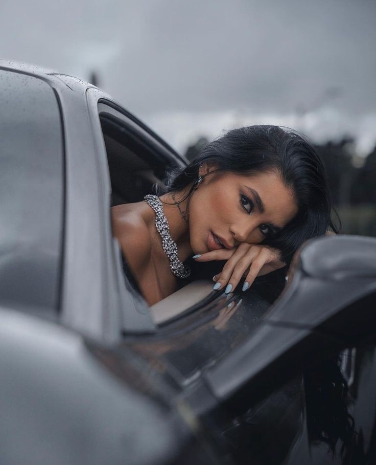 a woman leaning out the window of a car