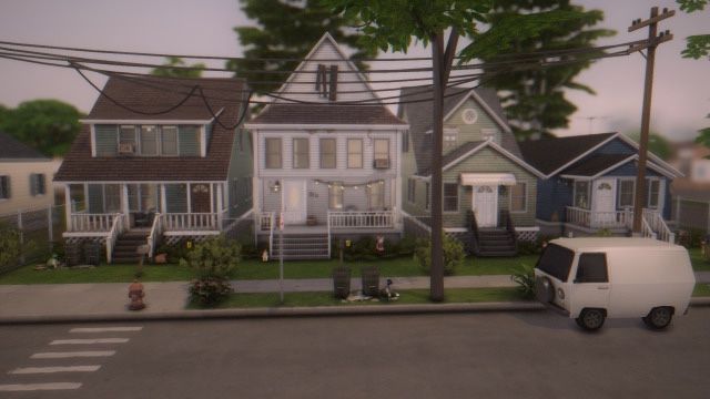 a white van is parked in front of some houses