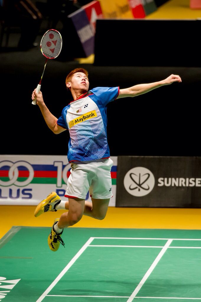 a man jumping up in the air to hit a tennis ball with his racket