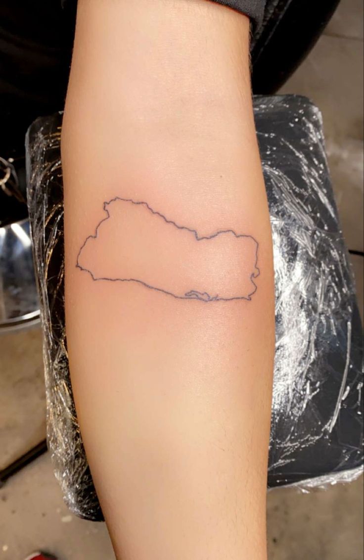 a person with a tattoo on their arm that is shaped like the shape of a map