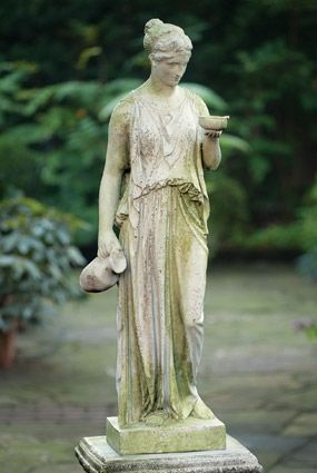 a statue of a woman holding a bowl and potted planter in her hand