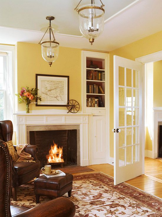 a living room filled with furniture and a fire place next to a fireplace in a home