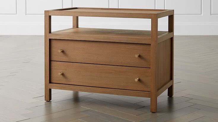 a wooden nightstand with two drawers on the bottom and one drawer open, in front of a white wall