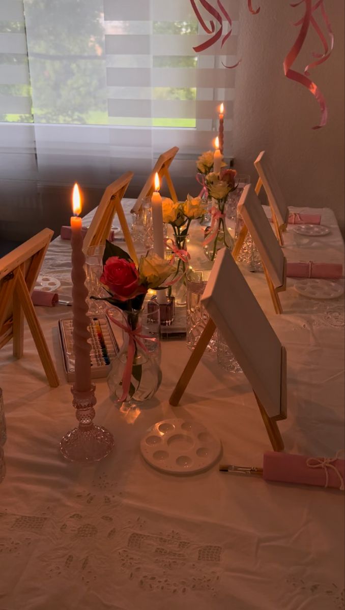 a table with candles and pictures on it