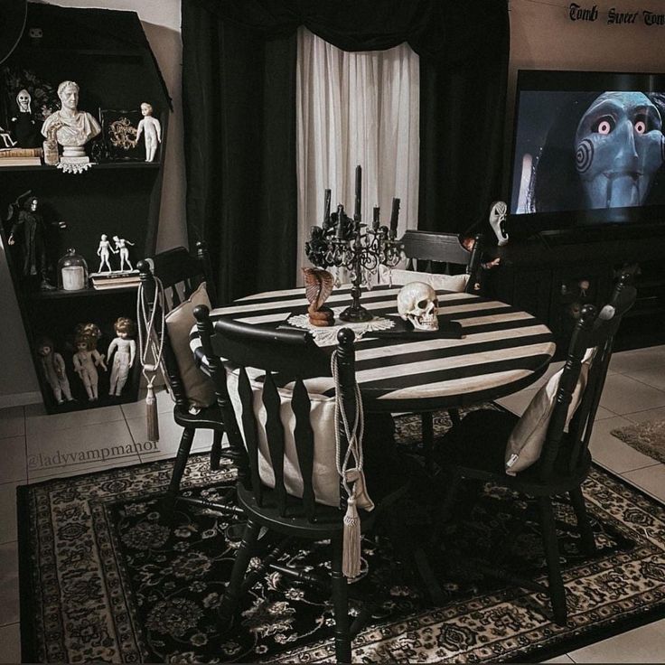 a black and white dining room with halloween decorations