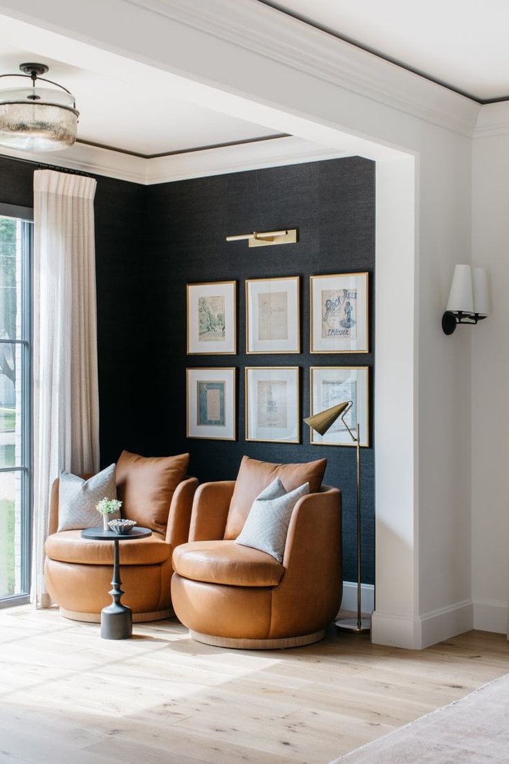 a living room filled with furniture and pictures on the wall