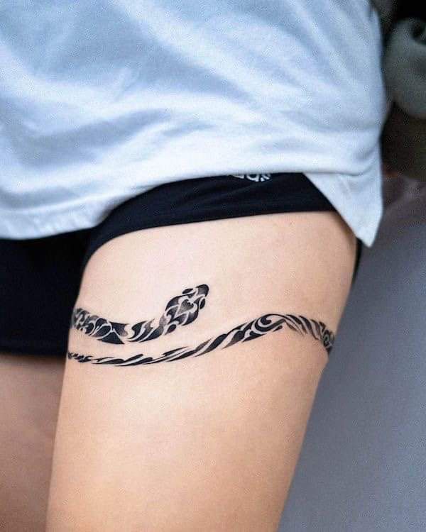 a woman with a tattoo on her thigh