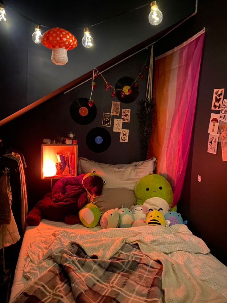 a bed with two stuffed animals on top of it and some lights hanging from the ceiling