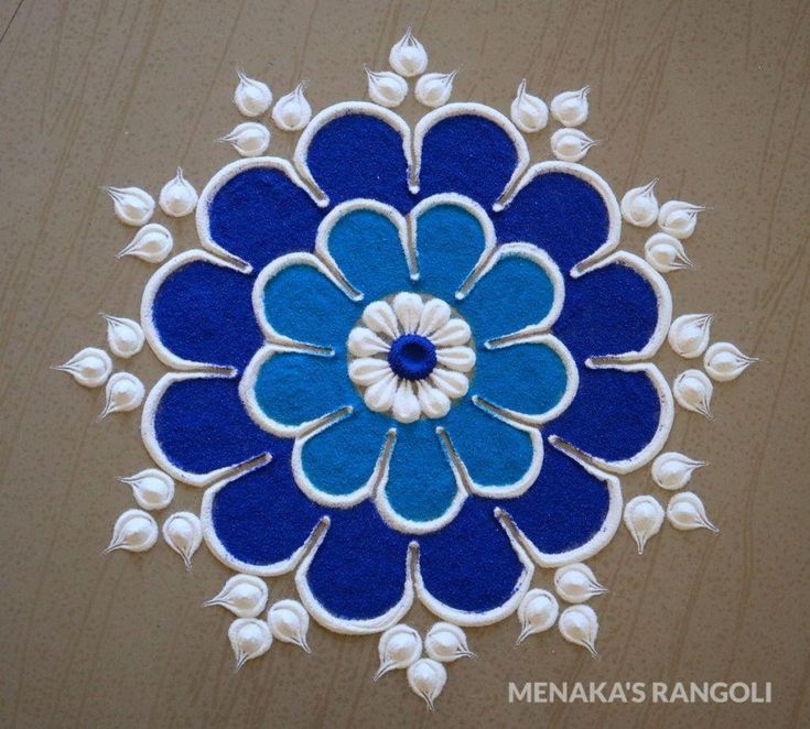 a blue and white flower design on a wooden surface